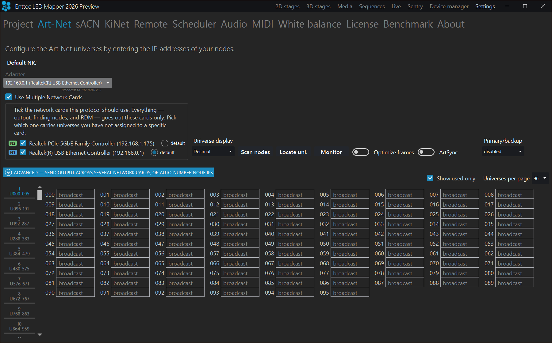 The top of the Art-Net settings page with Use Multiple Network Cards ticked. The Default NIC drop-down above it is greyed out showing 192.168.0.1 (Realtek(R) USB Ethernet Controller). Beside it a bordered panel explains that ticked cards carry output, node discovery and RDM, and lists two cards: a green N2 badge against Realtek PCIe 5GbE Family Controller (192.168.1.175) with its default radio unselected, and a blue N1 badge against Realtek(R) USB Ethernet Controller (192.168.0.1) with its default radio selected. Both tick boxes are ticked. The Advanced band, Universe display, Scan nodes, Locate uni., Monitor, Optimize frames, ArtSync and Primary/backup controls sit to the right and below, with the universe grid beneath.