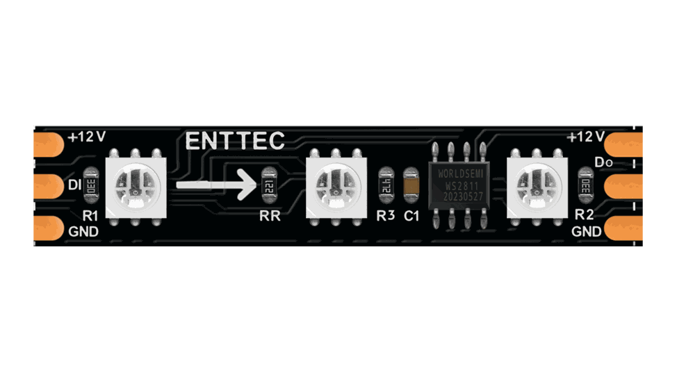 Close-up of the black PCB strip, three LEDs and a WS2811 driver chip between copper solder pads marked ENTTEC, +12V, DI, Do and GND.