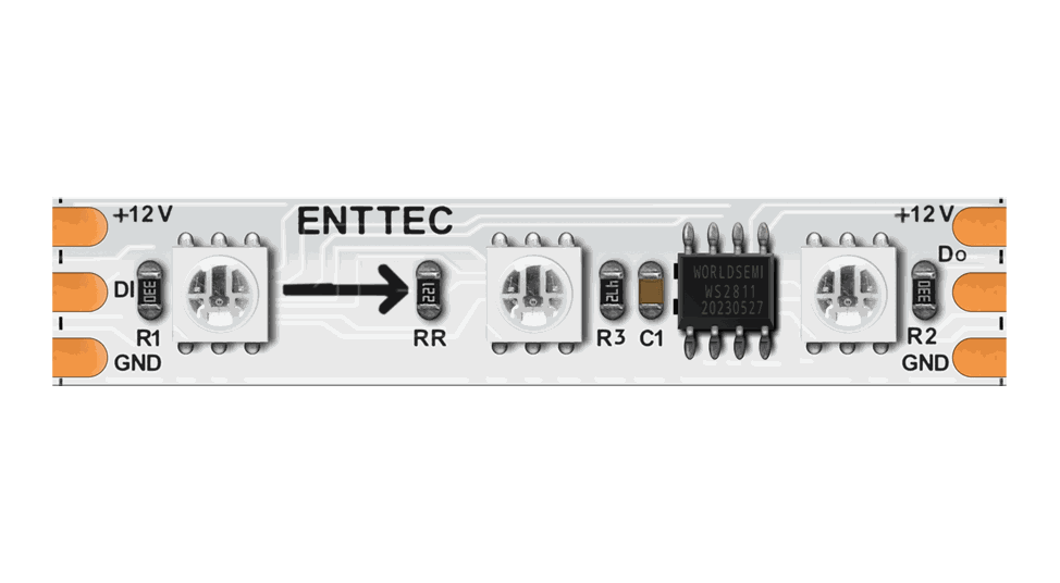 The same strip on a white PCB, three LEDs and a WS2811 driver chip between copper solder pads marked ENTTEC, +12V, DI, Do and GND.