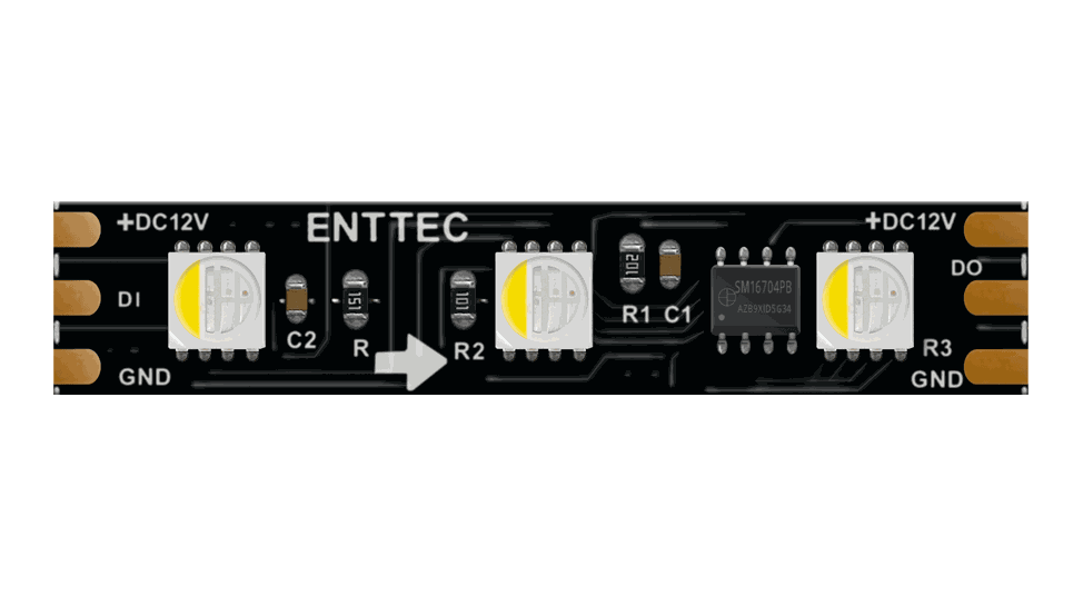 Close-up of the black PCB strip, three LED packages of four emitters each between copper solder pads marked +DC12V, DI, DO and GND.