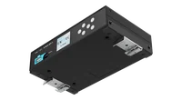 The underside of the S-PLAY SP1-1 in grey, tipped to show two black mounting bars screwed across it, each carrying a sprung metal DIN rail clip, with the front panel and its screen visible at the left.