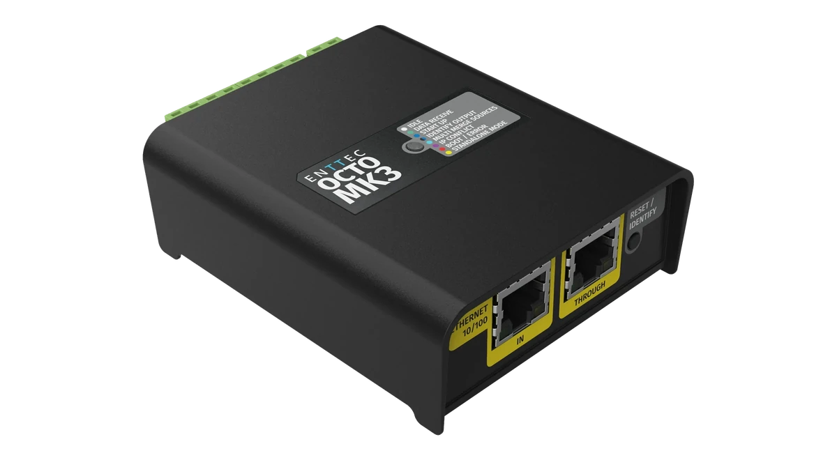 The OCTO MK3 from above at an angle, its lid printed 'ENTTEC OCTO MK3' beside the grey LED legend, the yellow ETHERNET 10/100 IN and THROUGH sockets and RESET / IDENTIFY button on the near face and green terminals along the far edge.