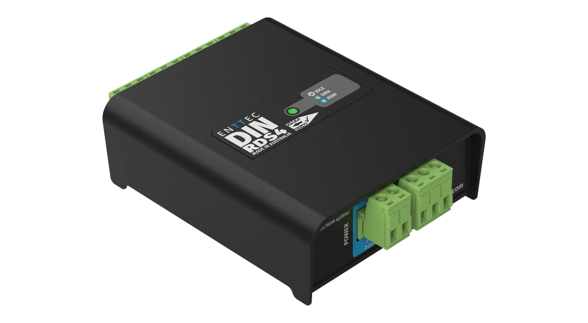 The DIN RDS4 seen from above its power end, the lid printed with ENTTEC DIN RDS4 and the DMX/RDM arrow, and the near face carrying a blue POWER block marked 7-24V DC beside two green plug-in terminals, with the output terminals along the far edge.