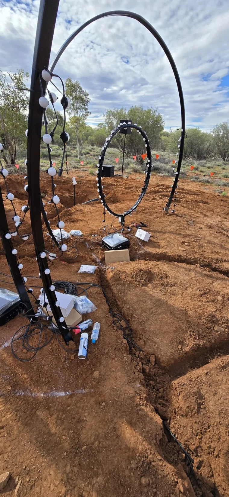 Pixel dots being fitted along a hoop, with cabling and equipment boxes in the trench below