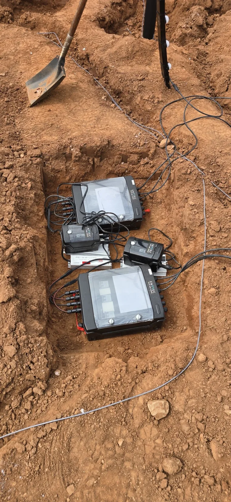 Power supplies and pixel injectors laid out on the red earth, wired into the run