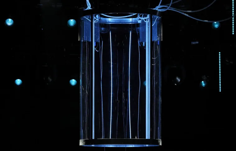 Detail of the tank, strips of pixels in clear tubes waving like water against the dark stage