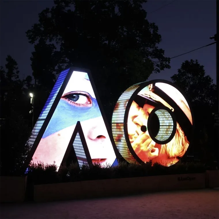 Close-up player portraits on the front screens, an eye filling the A and a capped player inside the O