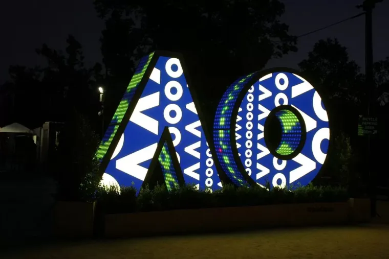 Night view from the right, white circles and chevrons on navy with green ball texture inside the O