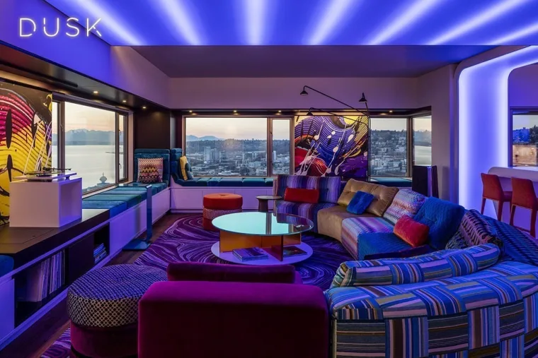 The identical view at dusk, blue and violet cove light raking across the ceiling and the word Dusk in the corner