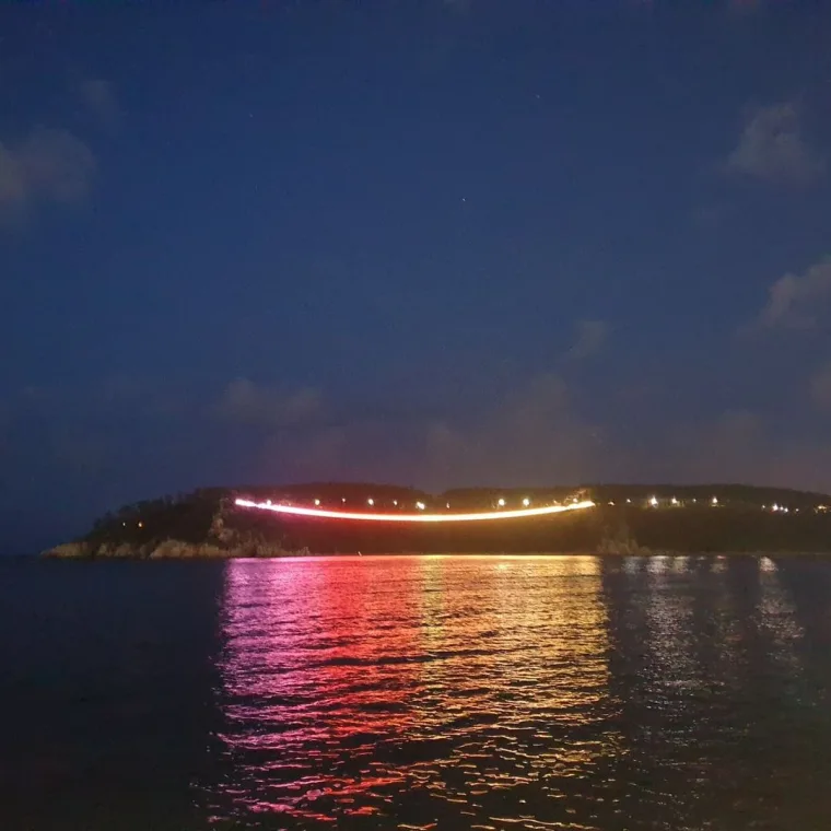 Later in the evening from the same bay, the bridge running red and orange with pink light stretched across the water