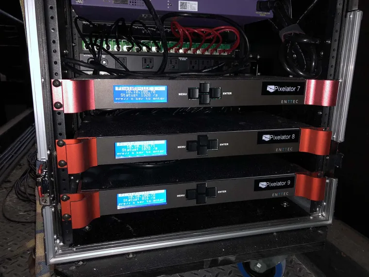 Three ENTTEC Pixelators stacked in a road case, labelled 7, 8 and 9, with patch cabling running above them