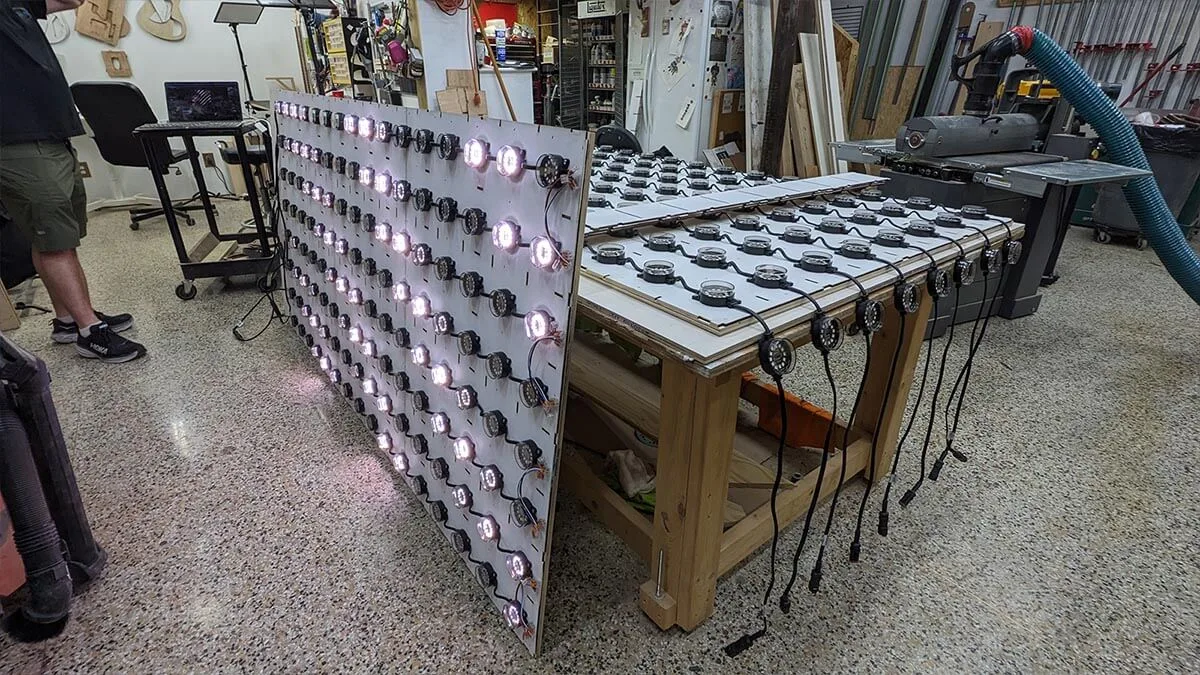 The finished panel stood on its edge in the workshop, its dots lit white and pink with cabling looped along the bench
