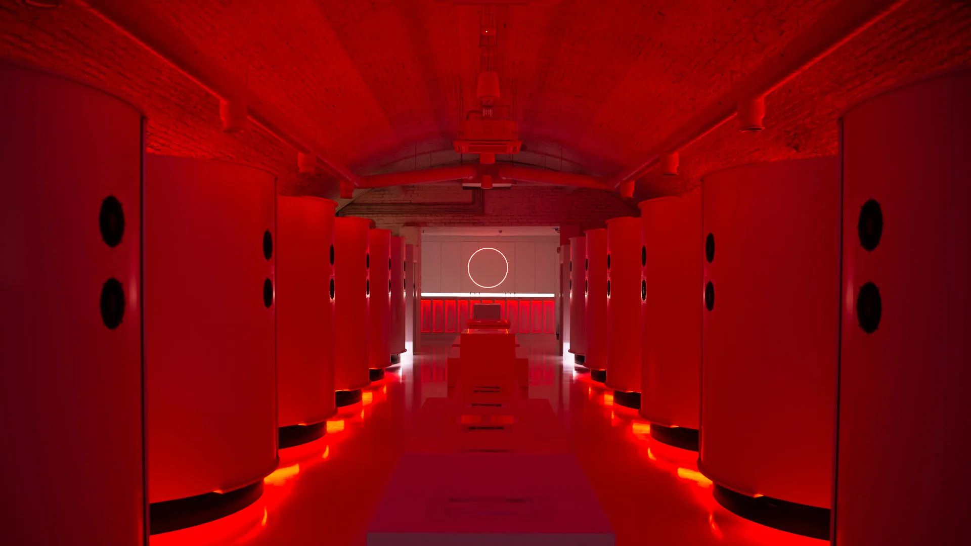 The pod arch flooded entirely in red, floor, doors and brick vault all taking the same colour