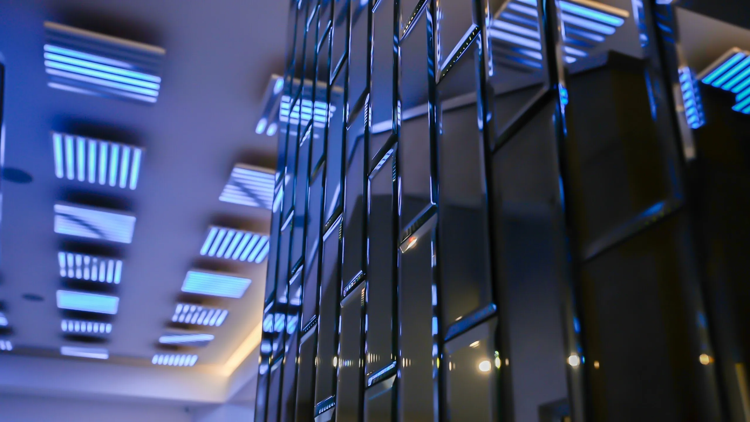 Pods lit blue overhead, reflected in a faceted mirrored column at the right of frame