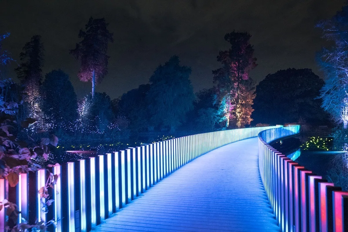 Standing on the bridge deck, the walkway washed blue between rows of colour changing uprights