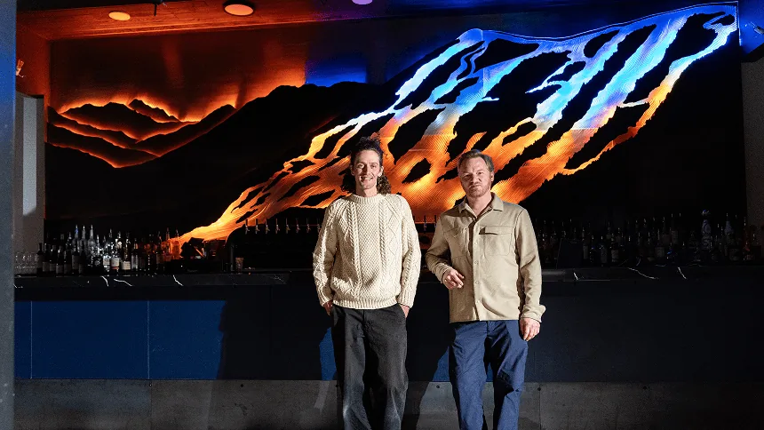Bland Hoke and Dan Sanford standing in front of the finished, lit SnowGlow installation