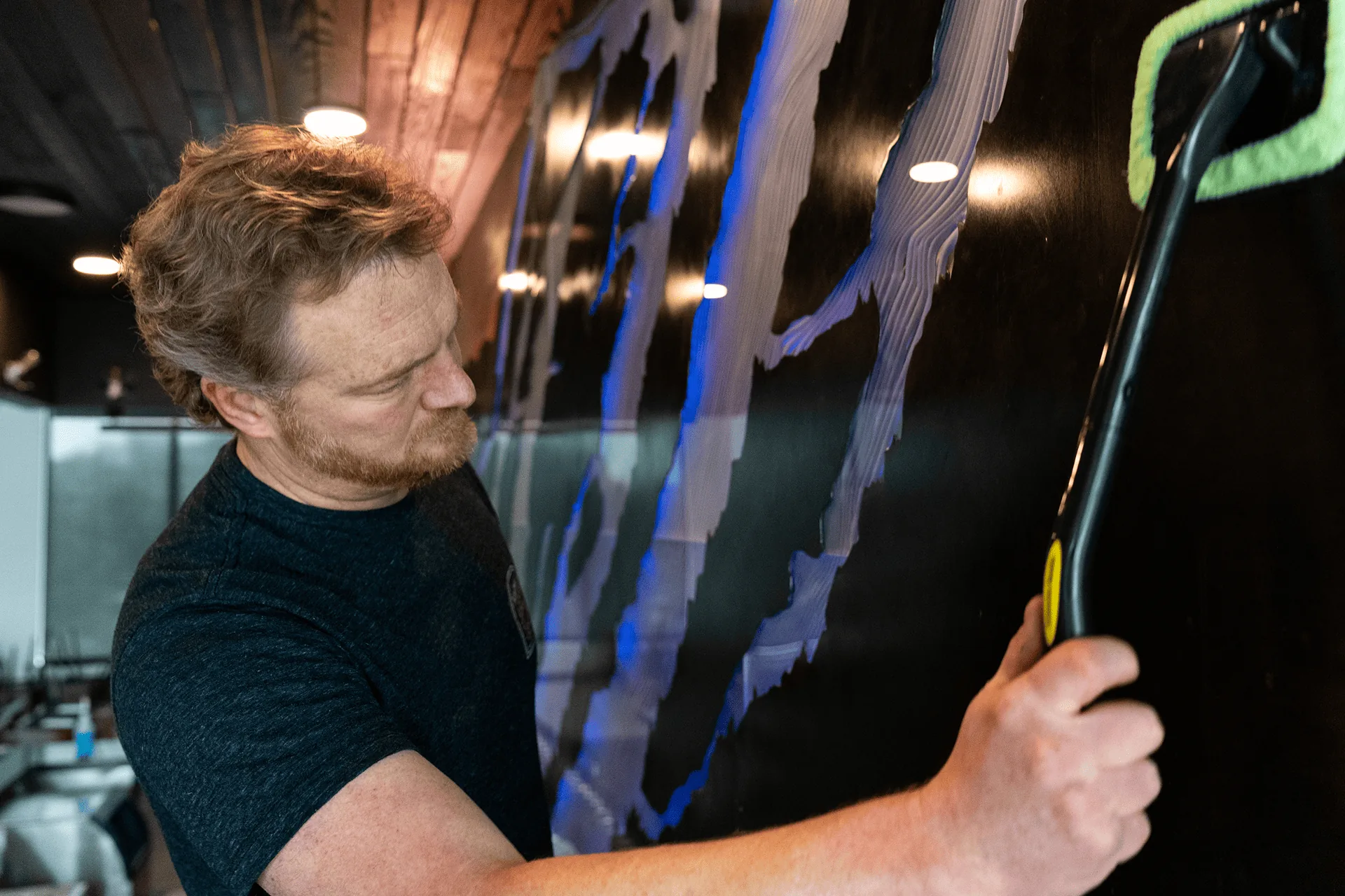 An installer working across the face of the translucent carved acrylic panels