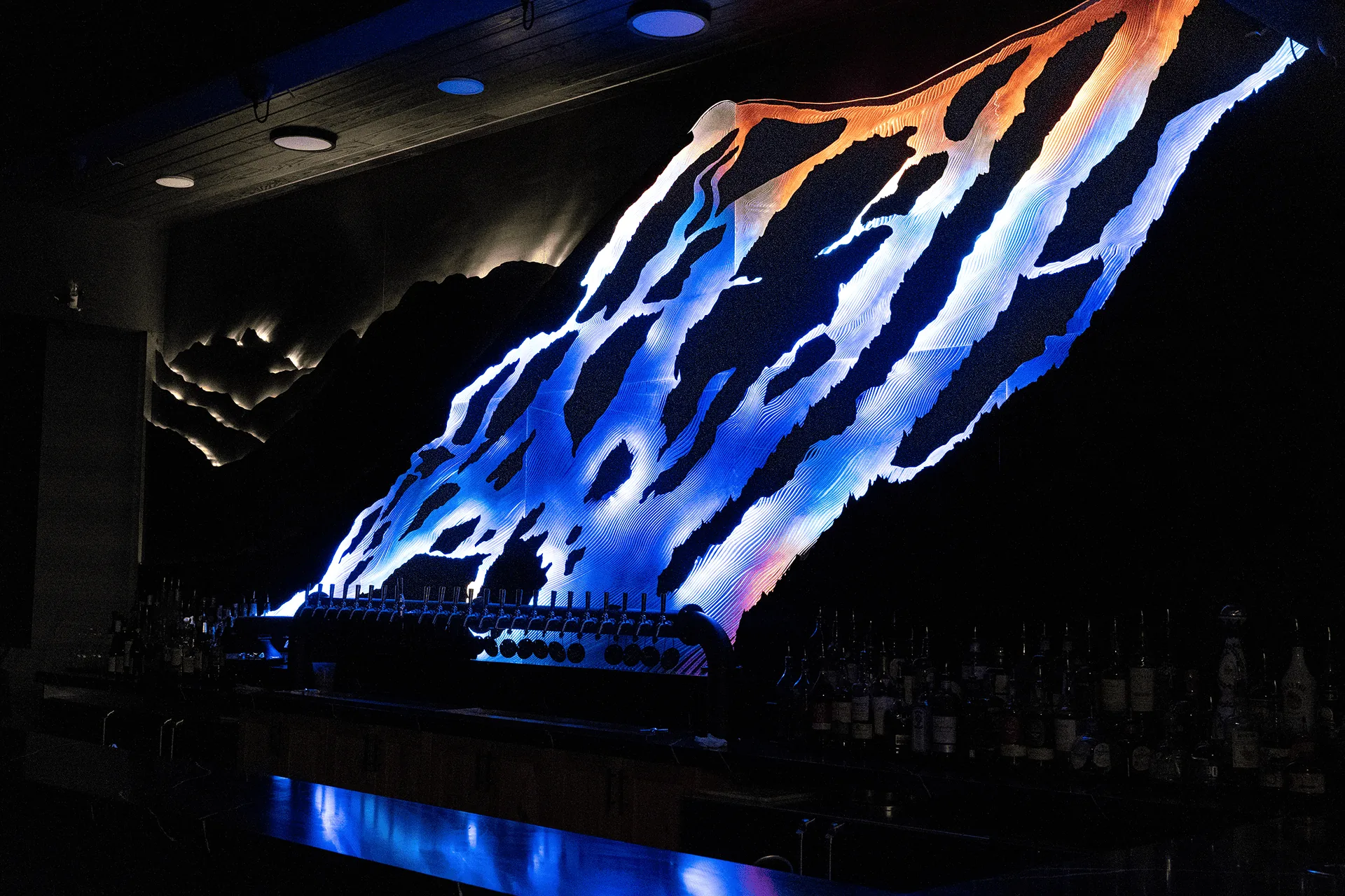 Blue and amber content running along the carved ridge lines above the back bar