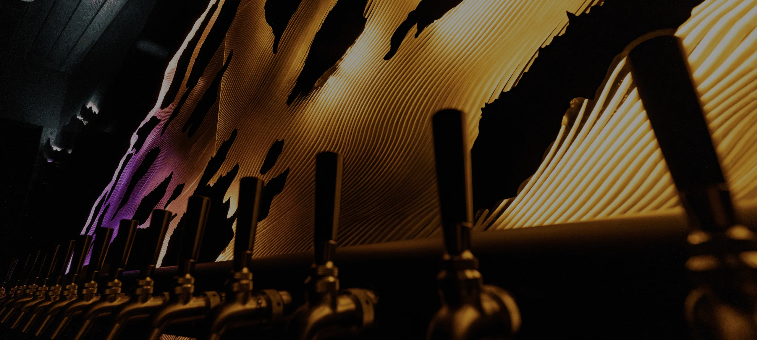 The SnowGlow sculpture lit in warm amber above the bar at Aurora restaurant