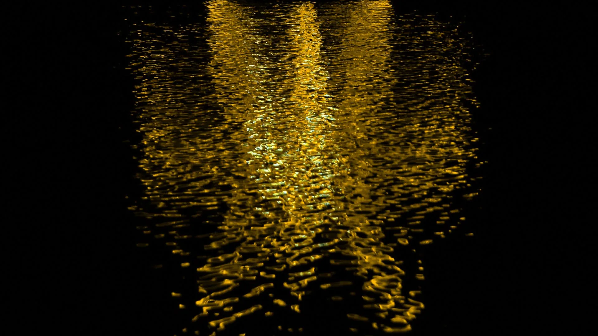 Only the water, the sculpture off frame, its warm yellow light broken into thousands of ripples