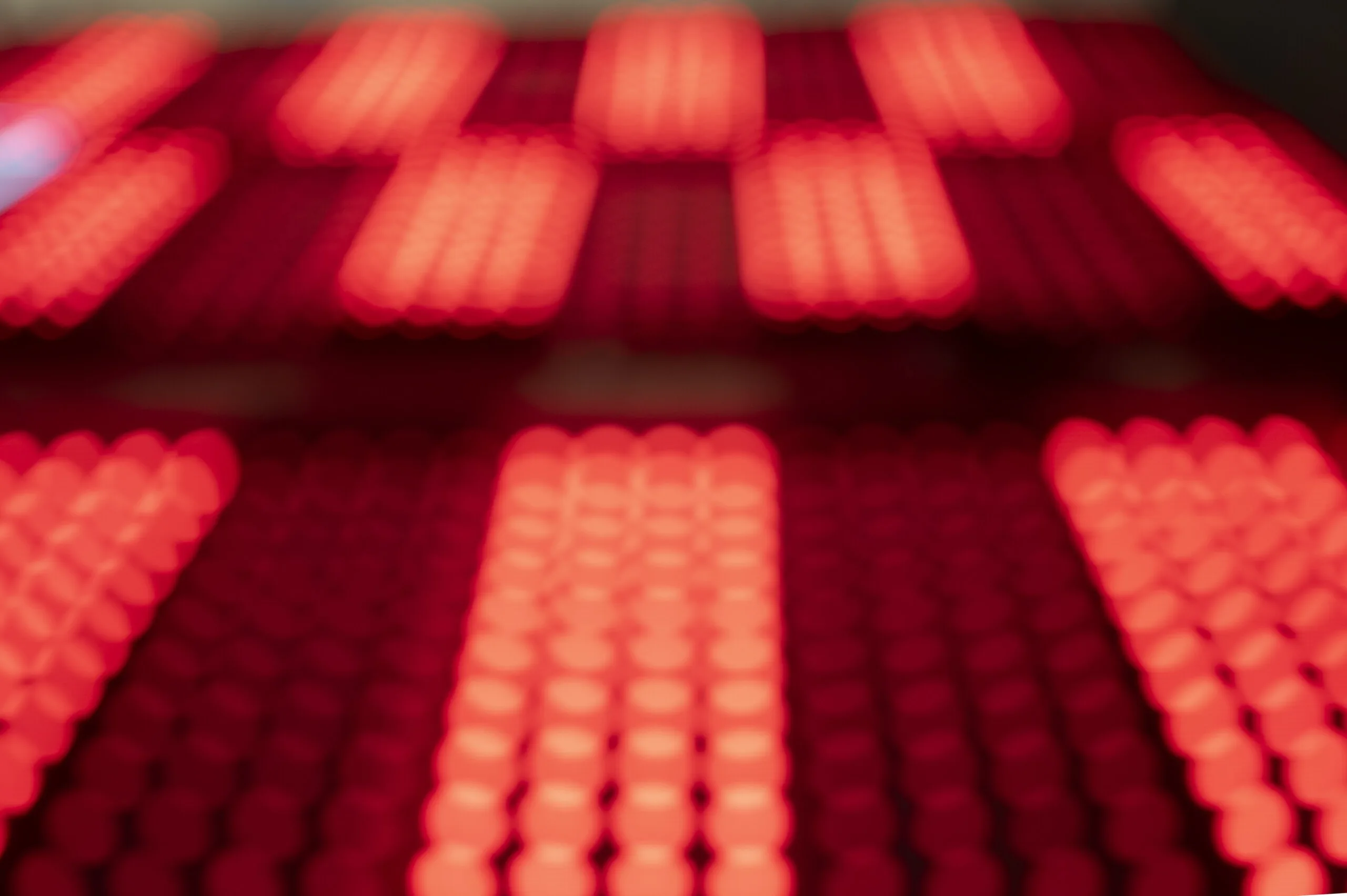 Defocused close-up of the dots, red and white lights smeared into soft vertical bars