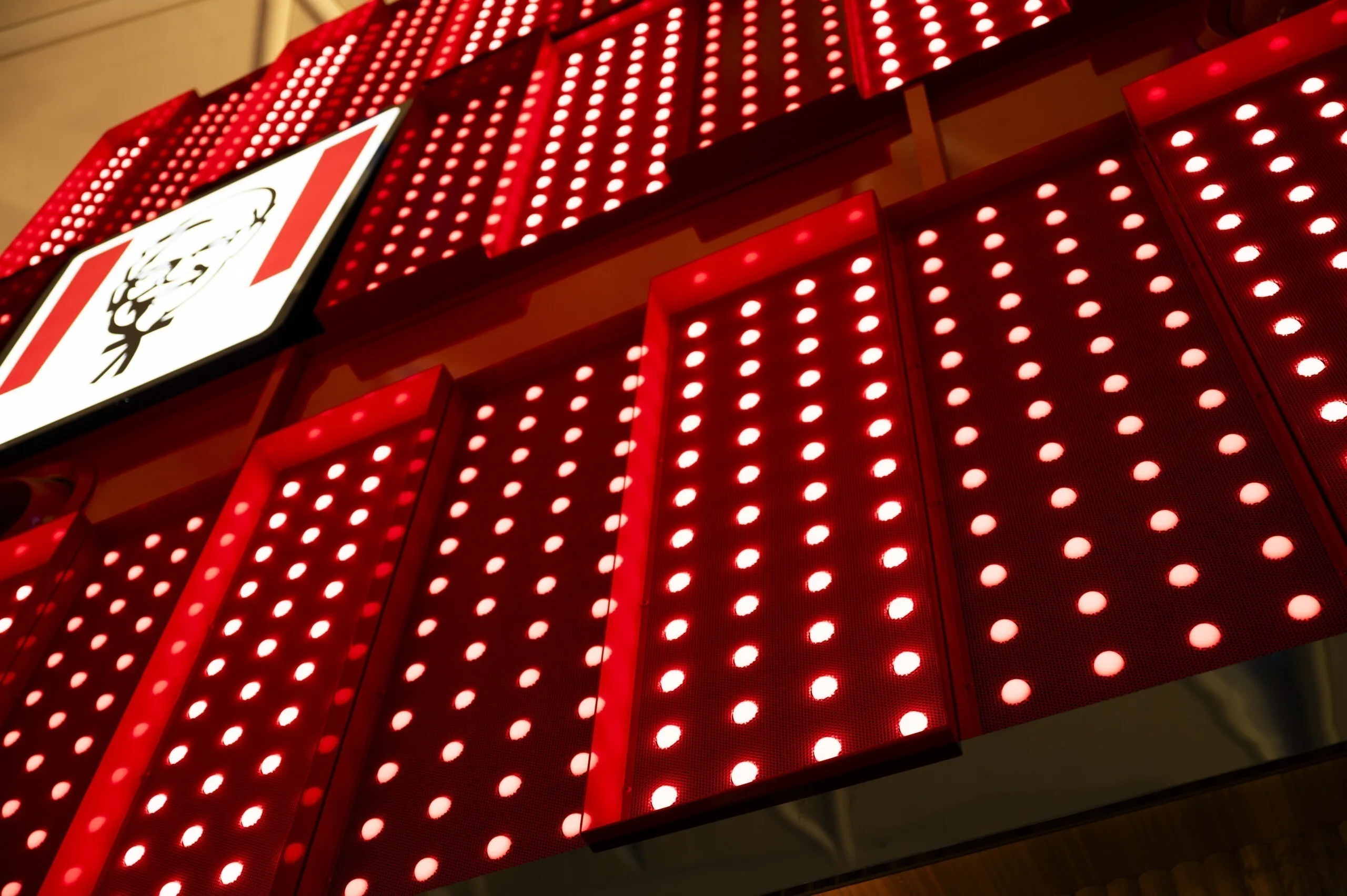 The logo panel at the left edge with lines of white dots sweeping away across the red panels